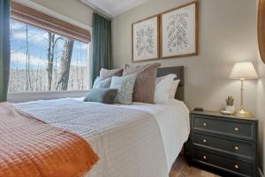a bedroom with a large bed and a window at The Hillside Retreat - Tiny Home in Hocking Hills in Logan