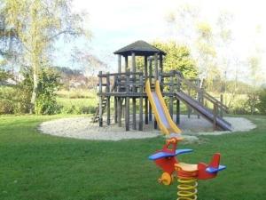 a park with a playground with a slide and a slideintend at Ferienhäuser Schlossberg mit zwei sep Schlafräumen, kostenlosem w-lan und neuer Hausausstattung - b48525 in Zandt