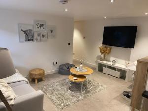 a living room with a couch and a table at Modern 2 bedroom Flat in Montrose in Montrose
