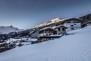 a ski lodge on top of a snow covered mountain at Ferienwohnungen direkt an der Skiabfahrt und MTB-Trails - b57507 in Sölden