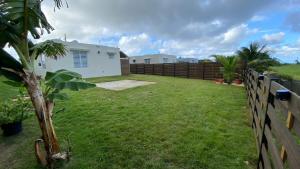 a backyard of a house with a fence at Casa Orillia's Del Mar in Isabela