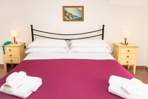 a bedroom with a large bed with two night stands at Hotel Fernanda in Letojanni