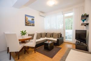 a living room with a couch and a table at Apartmani Nika Marangun in Dubrovnik