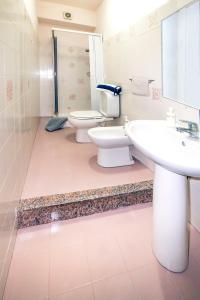 a bathroom with a toilet and a sink at Hotel Fernanda in Letojanni