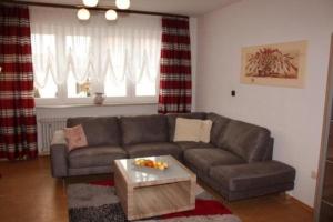 a living room with a couch and a coffee table at Ferienwohnung bis 6 Pers 1OG in Zandt