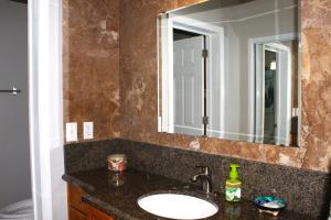 a bathroom with a sink and a mirror at Whale Hill Escape - Beach Views and Walk to Mannys in Puerto Peñasco +35 photos
