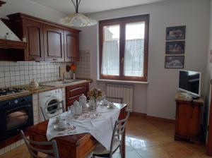 una cucina con tavolo e tovaglia bianca di Casa JaRi a San Giovanni Rotondo