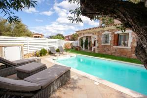 a swimming pool in front of a house at Villa Coclea con piscina in San Teodoro