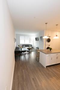 a kitchen and living room with a table and a dining room at Quaint Two-Bedroom Abode mins to NYC in Jersey City