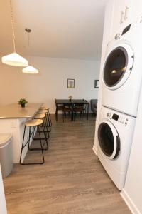 a kitchen and dining room with a washer and dryer at Quaint Two-Bedroom Abode mins to NYC in Jersey City