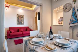 a dining room with a table and a red couch at Appartement in Naxos - b58780 in Giardini Naxos