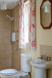 a bathroom with a toilet and a sink at Grove Fort Self Catering Farmhouse in Finnis +35 photos