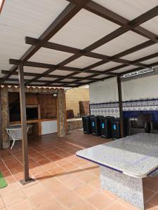 a pavilion with a table and some trash cans at Villa los Cantos in Toledo