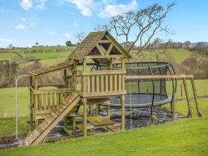 a playground with a slide and a play structure at 2 Bed in Aberystwyth TWLCT in Llanfihangel-y-creuddyn