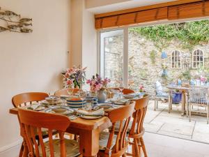 a dining room with a wooden table and chairs at 3 Bed in Charmouth DC121 in Charmouth