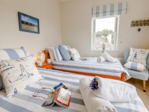 a room with two beds and a couch at 3 Bed in Charmouth DC121 in Charmouth