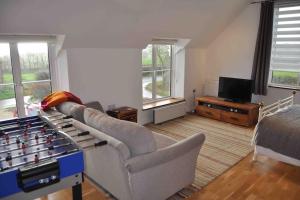 a living room with a couch and a tv at Bed@Byways, Holton in Wincanton