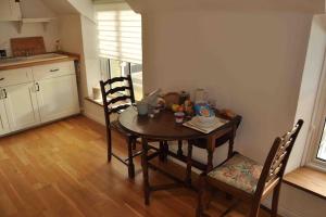 a table in a kitchen with two chairs and a table at Bed@Byways, Holton in Wincanton