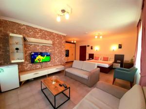 a living room with a couch and a room with a bed at Infinity Ruby Hotel in Fethiye