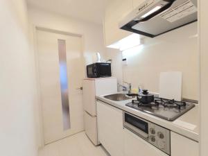 a small kitchen with a sink and a stove at LANG - Vacation STAY 21197v in Tokyo