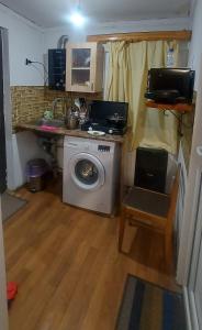 a laundry room with a washing machine and a table at Cozy House II in Tbilisi City