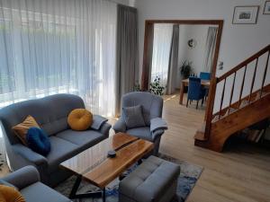 a living room with a couch and a table at Ferienhaus in Kolberg mit Grill und Garten in Kołobrzeg