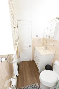 a bathroom with a white toilet and a sink at Close to NYC - Welcoming & Friendly 2-Bed Home in Union City