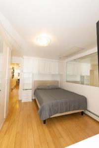 a bedroom with a bed and white cabinets at Close to NYC - Welcoming & Friendly 2-Bed Home in Union City