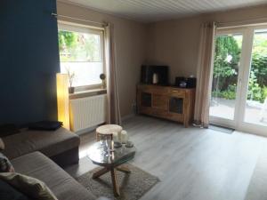 a living room with a couch and a coffee table at Ferienhaus in Elmenhorst mit Garten und Terrasse in Elmenhorst