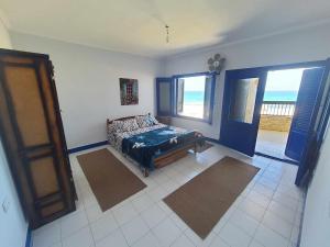a bedroom with a bed and a view of the ocean at Hotel appartment sea view 3 bedrooms 3 toilets 3rd floor free wifi Bellevue village agami alexandria families are preferred available all year days in Alexandria