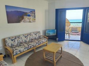 a living room with a couch and a view of the ocean at Hotel appartment sea view 3 bedrooms 3 toilets 3rd floor free wifi Bellevue village agami alexandria families are preferred available all year days in Alexandria