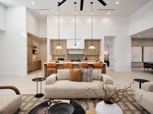 a living room with a couch and a kitchen at LUXE - Tulum House - New Build - Heated Pool in Scottsdale