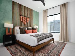 a bedroom with a large bed and a large window at LUXE - Tulum House - New Build - Heated Pool in Scottsdale