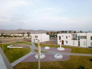 アシアにあるDúplex frente al Mar, Playa Chocaya, costado Real Club Asiaの白い建物のある公園の空中風景