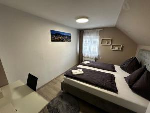 a bedroom with a bed and a desk with a laptop at Labis Room 2“ in Salzburg