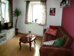 a living room with a couch and a table at Ferienwohnung für 2 Personen ca 60 qm in Obernzell, Bayern Bayerischer Wald in Obernzell