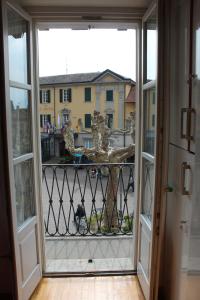 an open door to a balcony with a cat outside at Balconi san Giorgio in Varenna