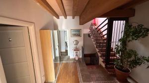 a hallway with a spiral staircase in a house at Balconi san Giorgio in Varenna +1 photo