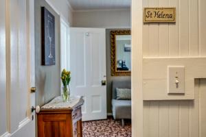 a hallway with a vase of flowers on a table at Calistoga Wine Way Inn in Calistoga