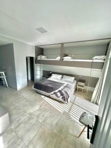 a bedroom with a bed and two bunk beds at Reina Mora Hotel in La Rioja