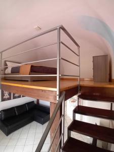 a room with a bunk bed and a staircase at Ognina Marina Gem in Catania