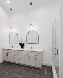 a bathroom with a sink and two mirrors at Monroe - Brand-New Remodel - Backyard Oasis in Phoenix