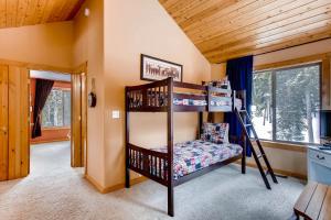a bedroom with two bunk beds in a room at Serene Mountain Cabin Nestled Amongst the Pines - Alpenhaus in Fairplay