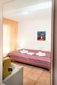 a bedroom with a large bed with towels on it at Hotel Fernanda in Letojanni