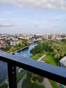 a view of a river from a balcony at Sloneczny Apartament na 14 Kondygnacji z widiokiem na Bydgoszcz in Bydgoszcz