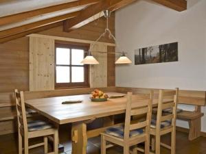 a dining room with a wooden table and chairs at Luxuschalet - altes Bauernhaus mit private Spa in Regen