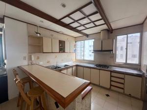 a kitchen with a table and two chairs in it at Amazing penthouse with stunning views & pool in Cartagena de Indias