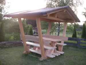 a wooden picnic table and bench in the grass at Ferienhaus "Lena" in Presseck