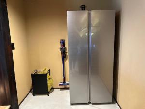 un frigorifero in acciaio inossidabile nell'angolo di una stanza di Tonegun - House - Vacation STAY 16434 a Sudagai