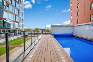 a swimming pool on the side of a building at Hobson Apartment with Pool and View in Auckland
